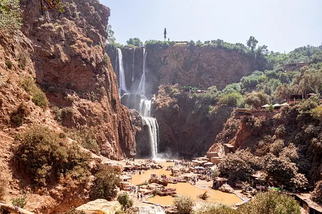 Ouzoud Falls in Morocco, a multi-tiered waterfall cascading down red cliffs near Marrakech.