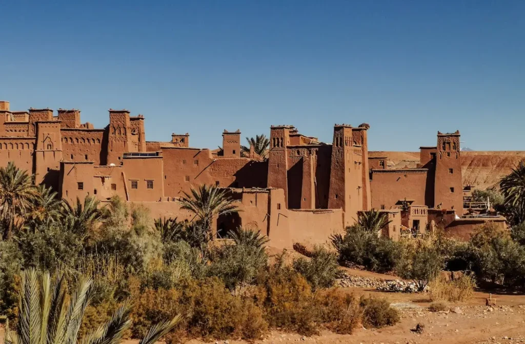 Ancient Moroccan kasbah architecture near Ouarzazate with palm oasis and desert scenery