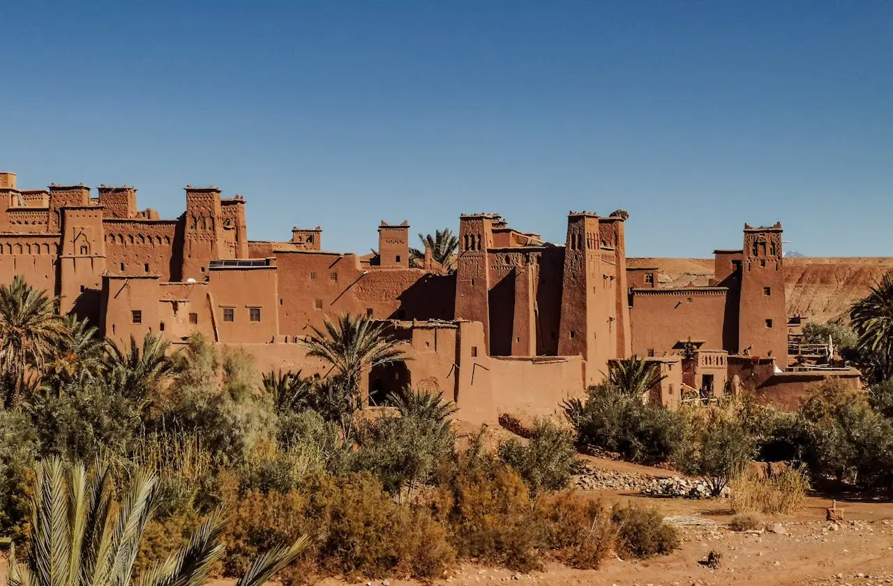 Ancient Moroccan kasbah architecture near Ouarzazate with palm oasis and desert scenery