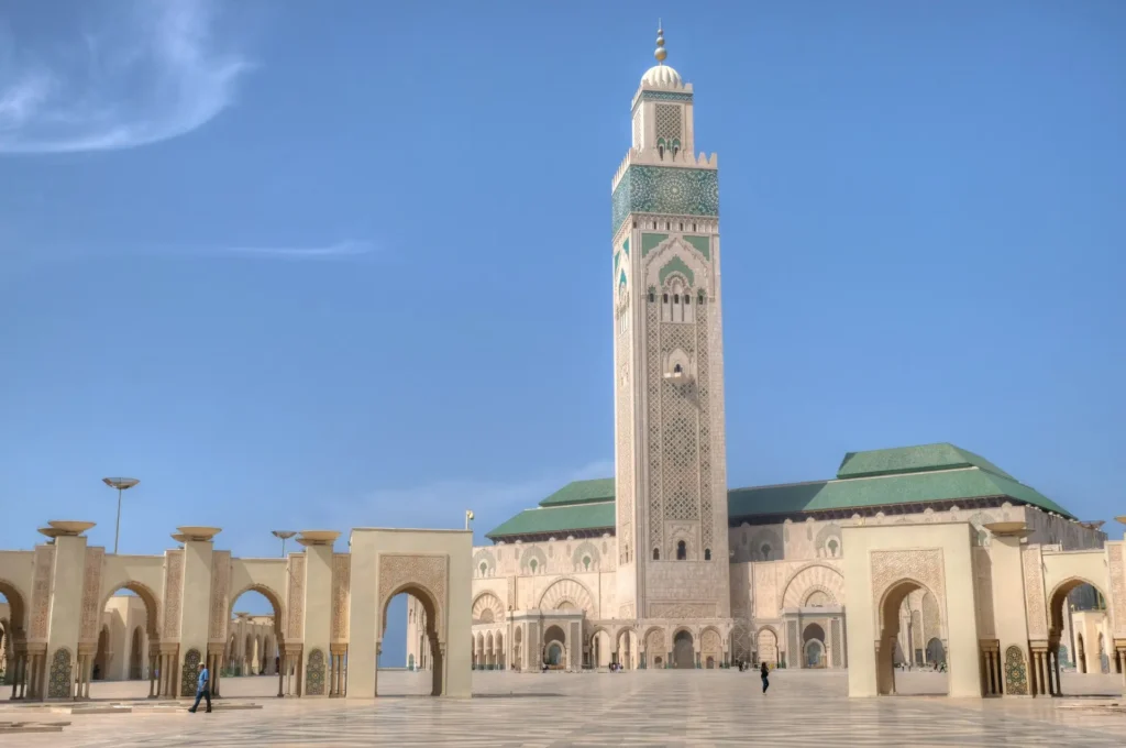 The magnificent Hassan II Mosque in Casablanca, Morocco, with its towering minaret and intricate Islamic architecture.