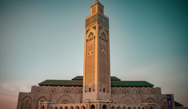 “Hassan II Mosque entrance with detailed Moroccan Islamic architecture in Casablanca.